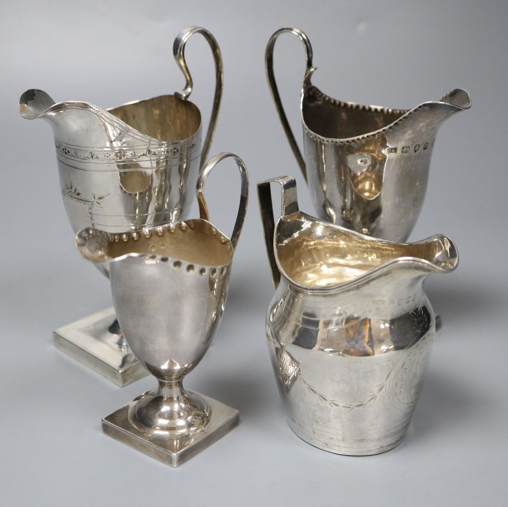 Four silver helmet-shaped cream jugs, approx 11oz